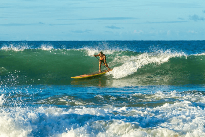 a man riding a wave on a surfboard in the ocean